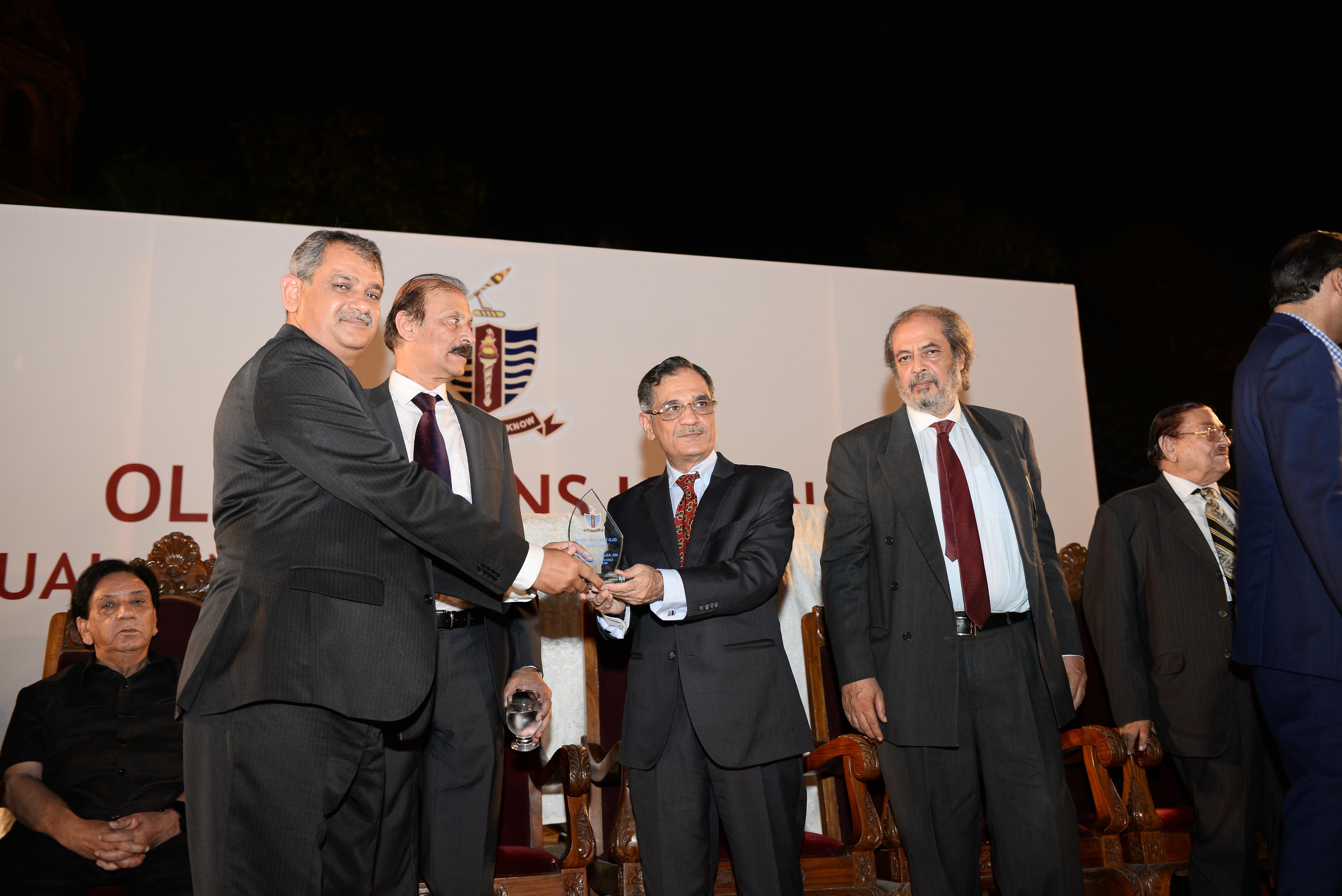 Mr. Asjad Ghani receiving his shield from the Chief Guest